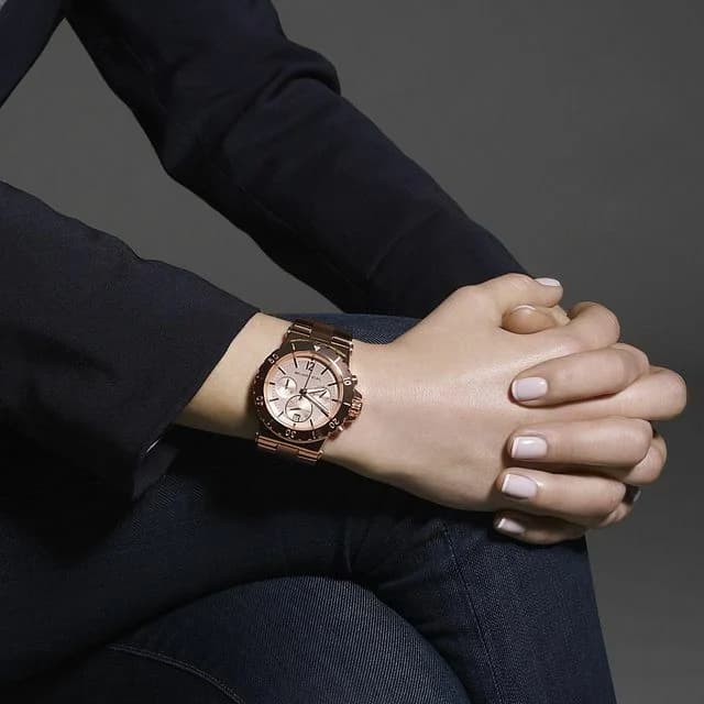 Bracelet Michael Kors MK5314 en acier or rose maillé, fermoir déployant, finition brillante, ajustable et confortable